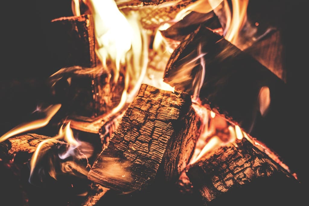 Vibrant campfire with burning wood and vivid flames, perfect for outdoor or cozy themes.